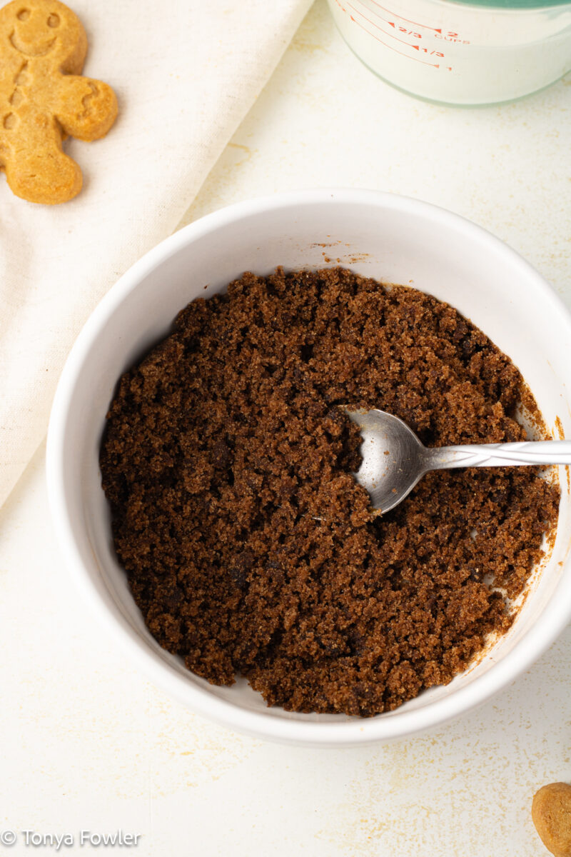 Brown sugar mixed with spices in a bowl with a spoon.