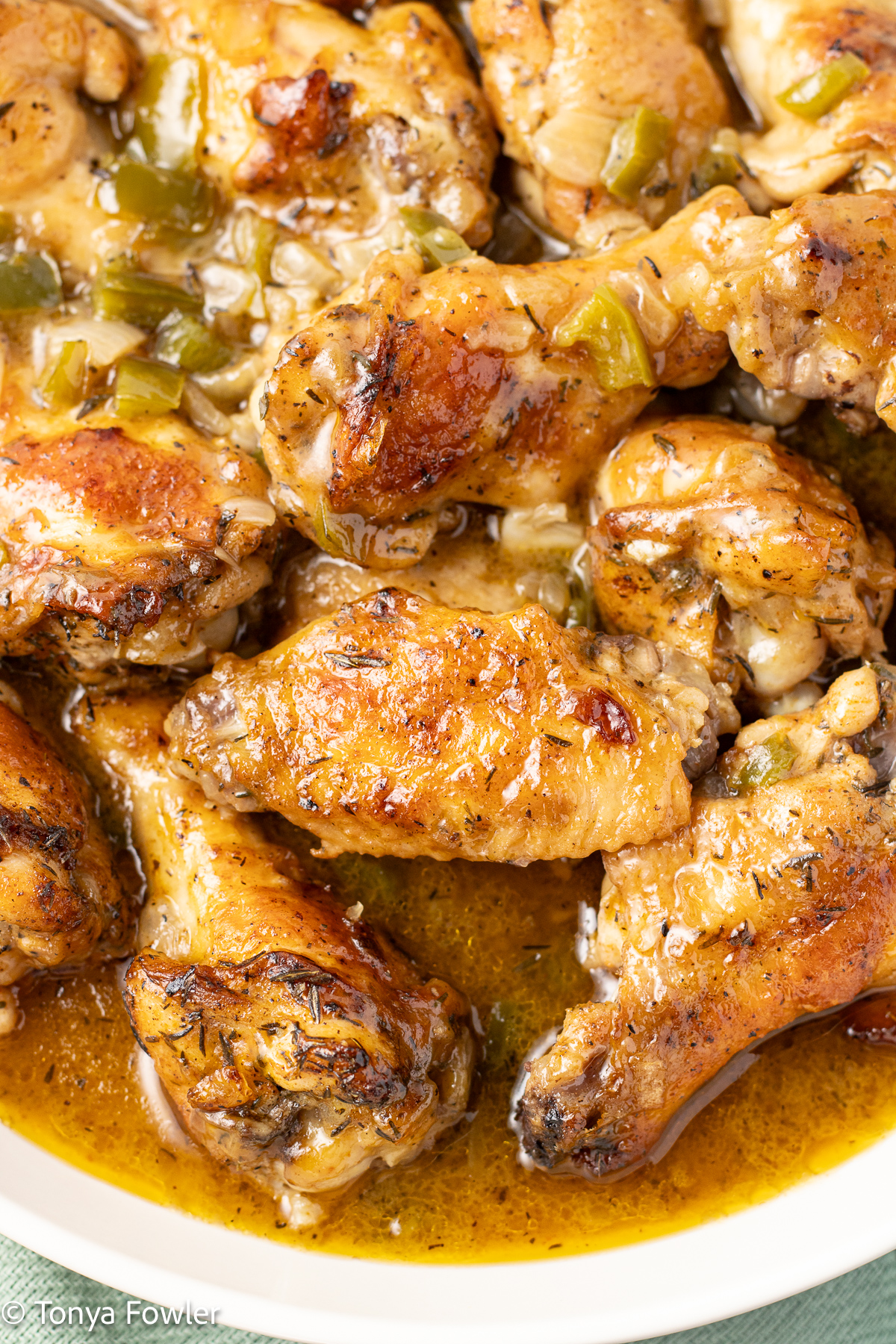 Smothered chicken wings in a bowl with gravy.