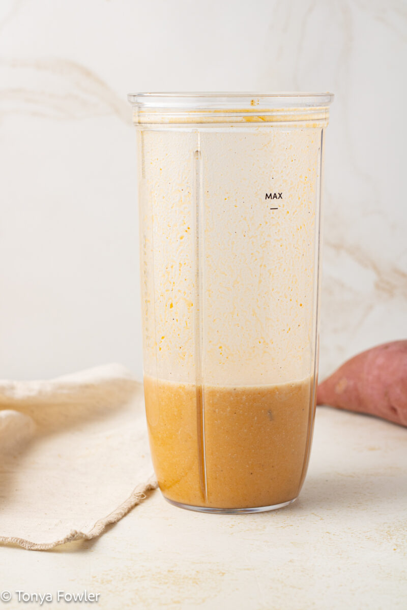 Straight on view of sweet potato puree in a blender.