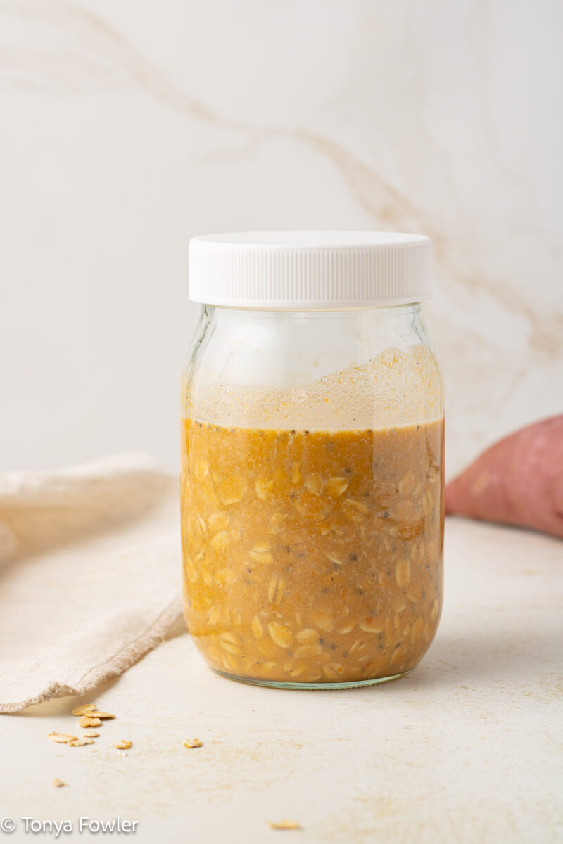 Sweet potato puree mixed with rolled oats in a mason jar.