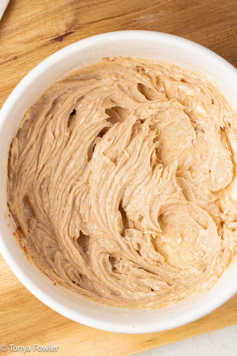 Overhead view of whipped cinnamon butter in a bowl. 