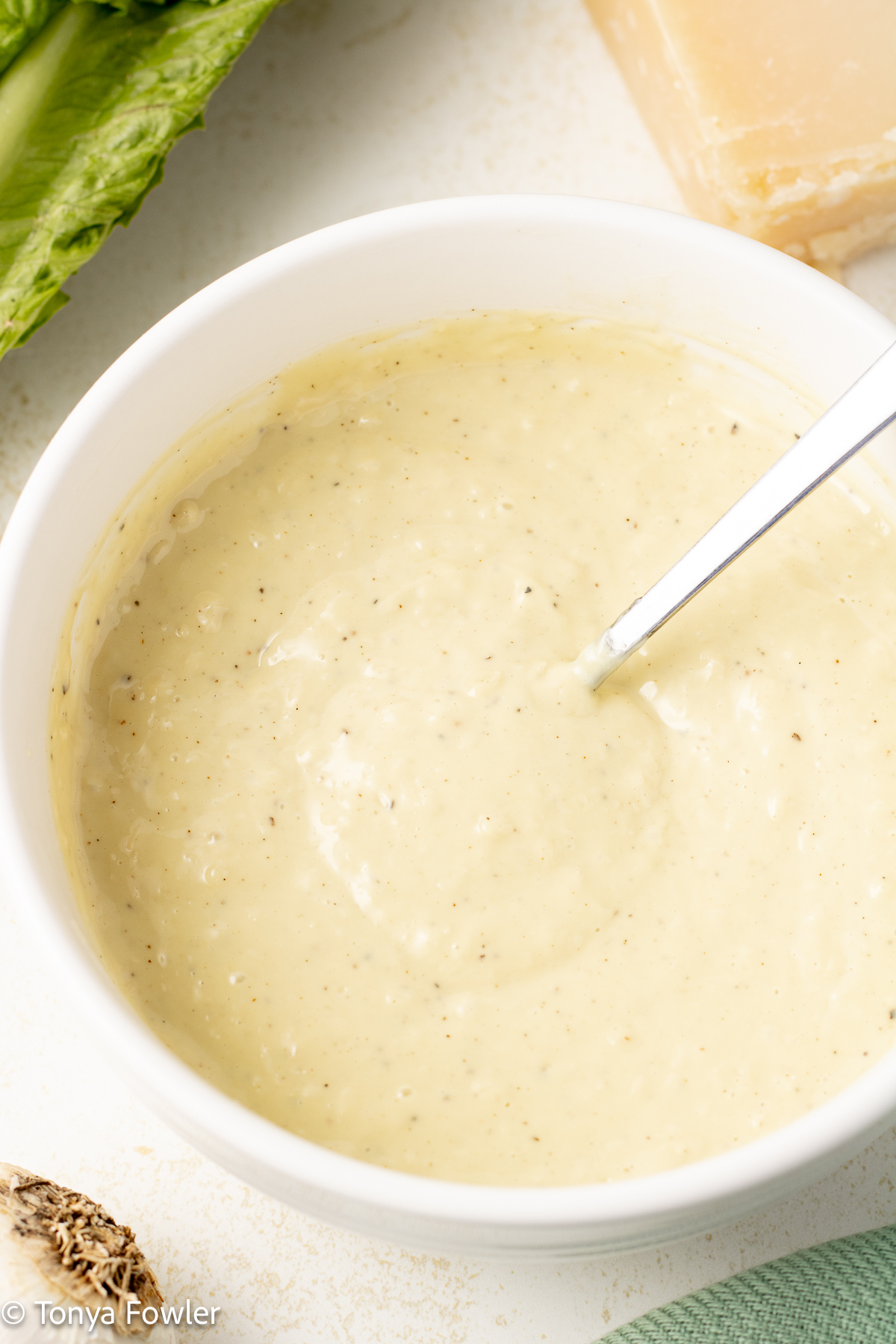 Salad dressing in a bowl in a spoon.