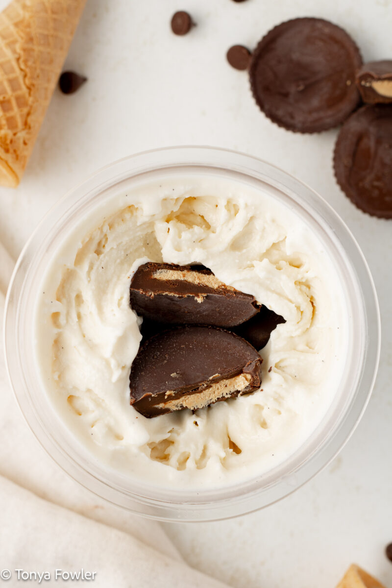 Ice cream with peanut butter cups cut in half stuffed in the middle. 