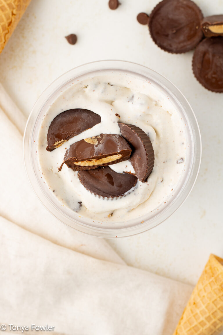 Overhead view of peanut butter cup ice cream topped with peanut butter cups.