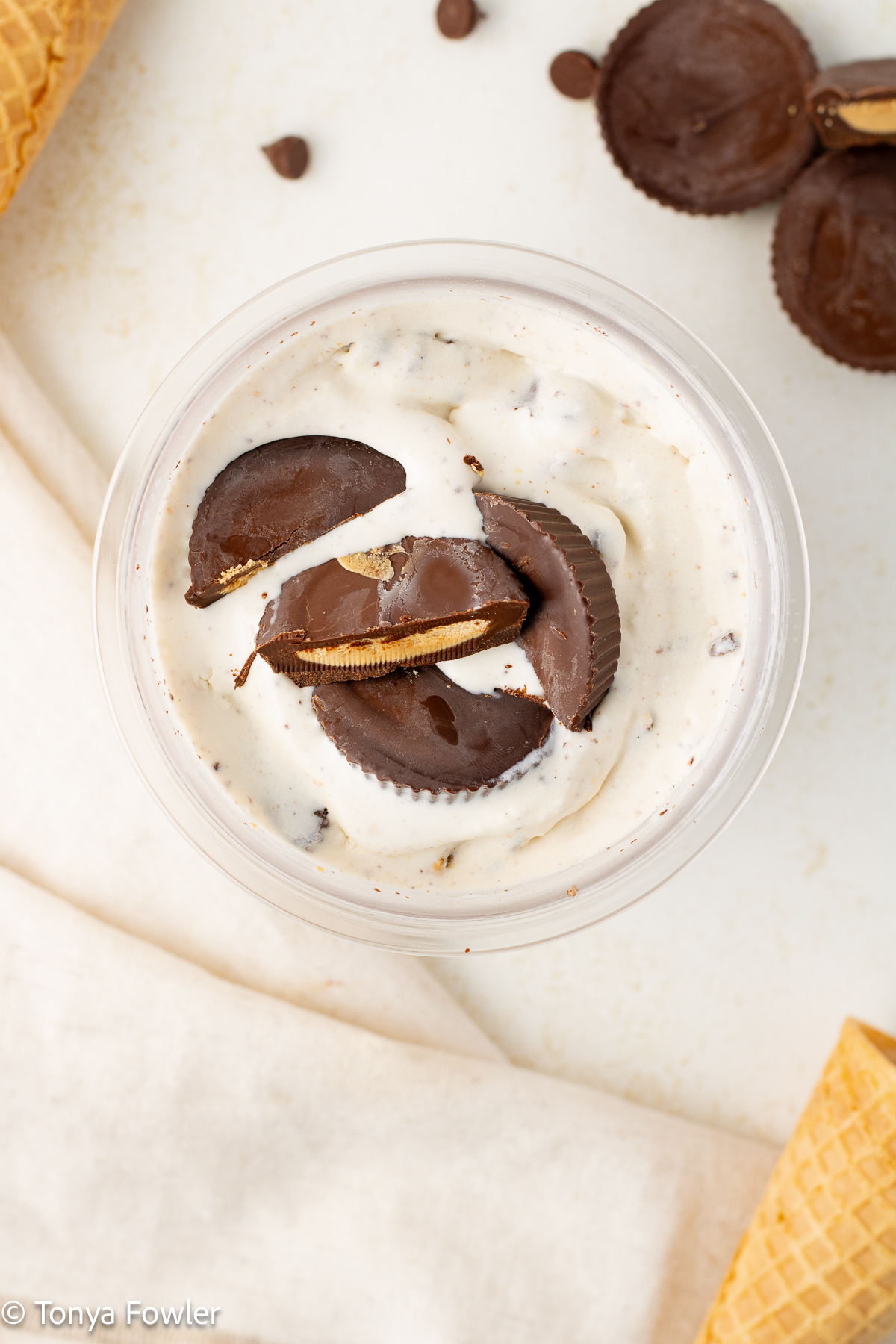 Overhead view of peanut butter cup ice cream topped with peanut butter cups.