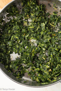 Cooked spinach in a skillet.
