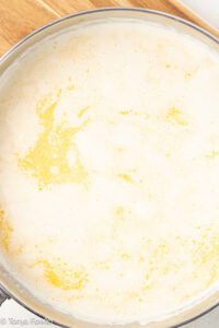 Cream and butter simmered together in a skillet.