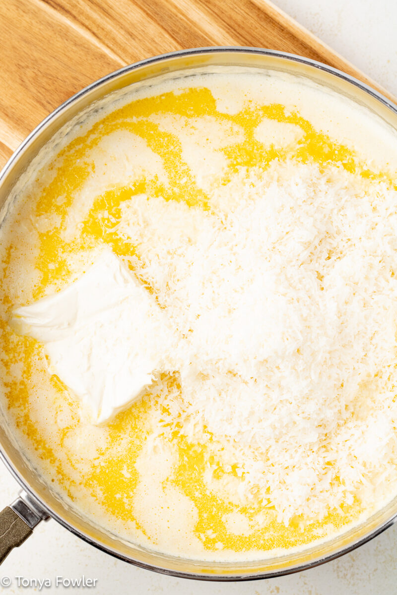 Cream, cream cheese, butter and parmesan cheese in a skillet.