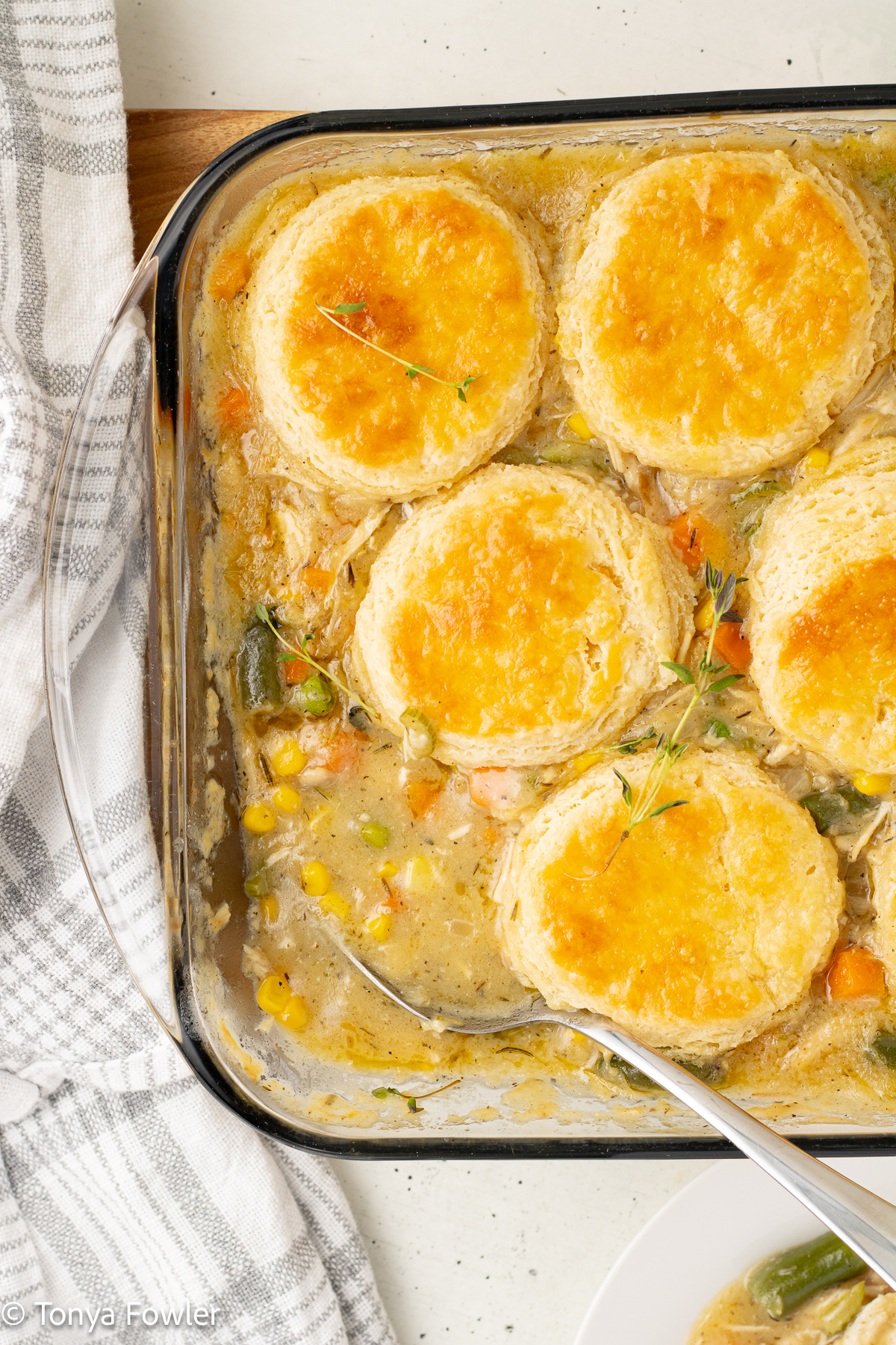 Overhead view of pot pie in a baking dish with a spoon.