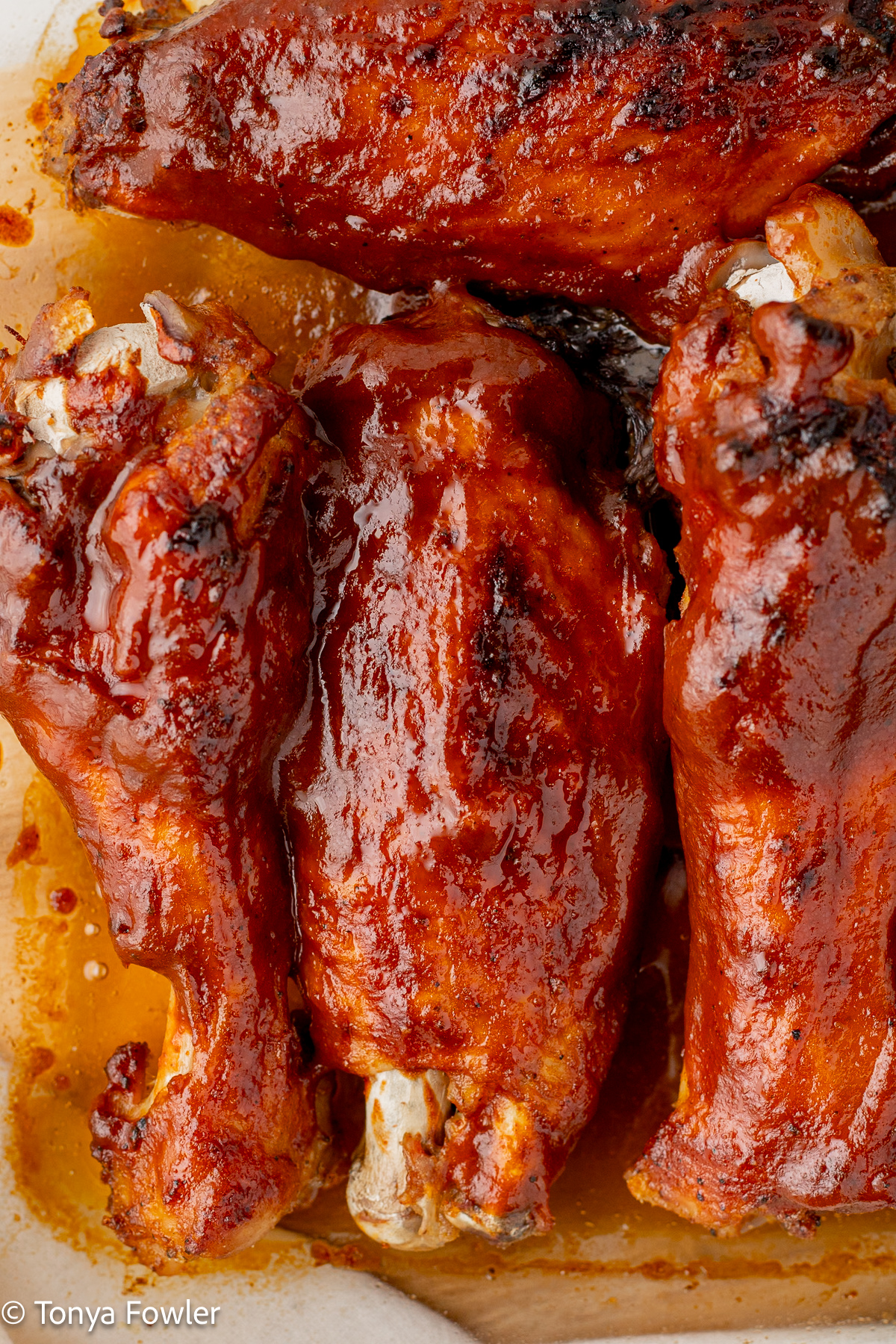 Close up image of bbq wings in  a baking dish. 