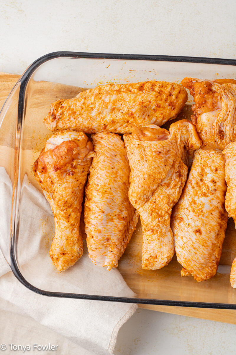 Raw turkey wings in a baking pan.