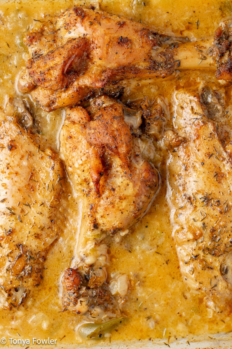 Close up image of Cajun Smothered Turkey Wings in a baking dish.