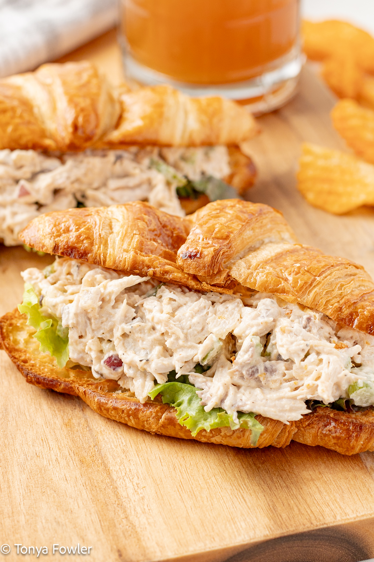Close up image of smoked turkey salad sandwich on a cutting board.