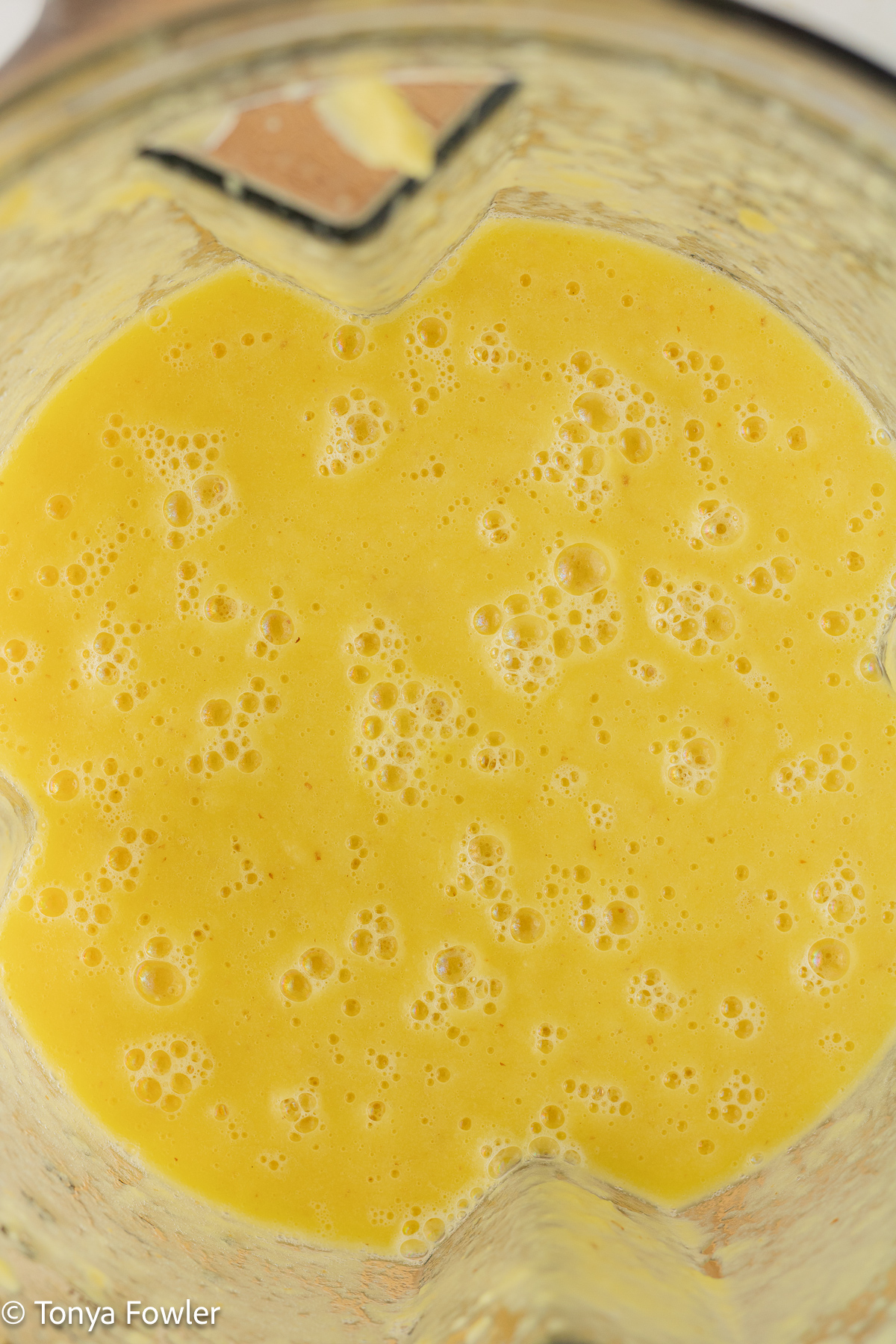 Blended pineapple, ginger and lemon in a blender.