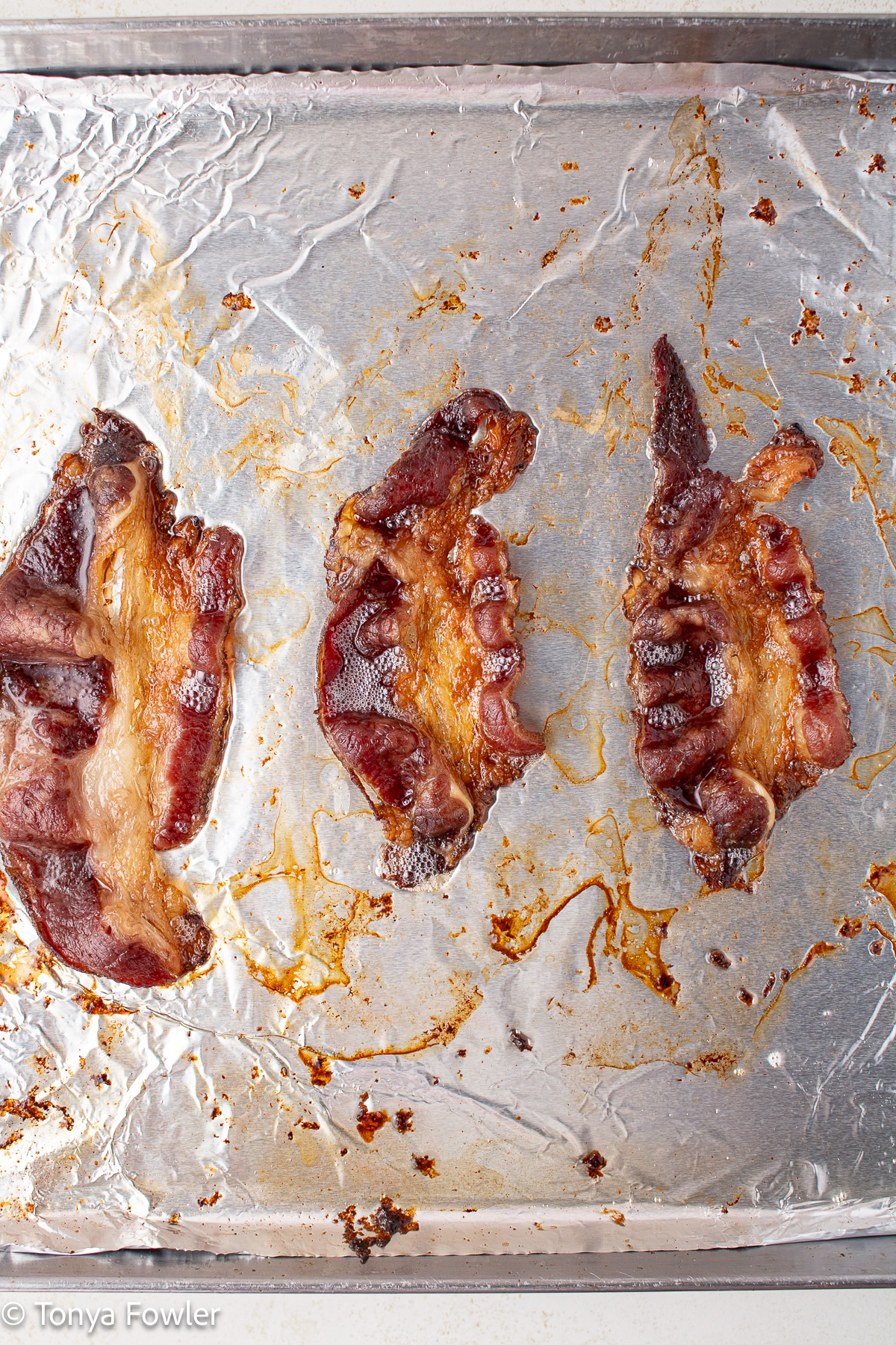 Cooked beef bacon on a sheet pan.