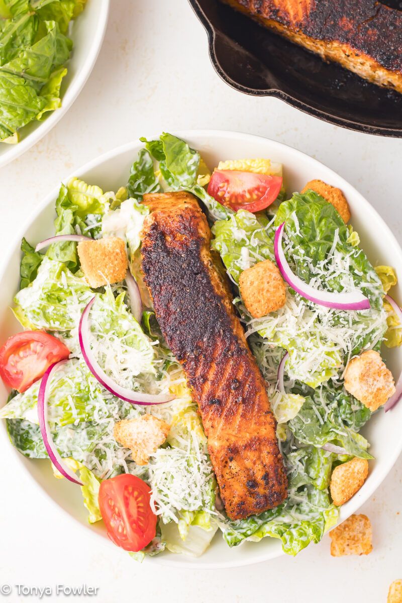 Overhead view of Blackened Salmon Caesar Salad in a bowl.