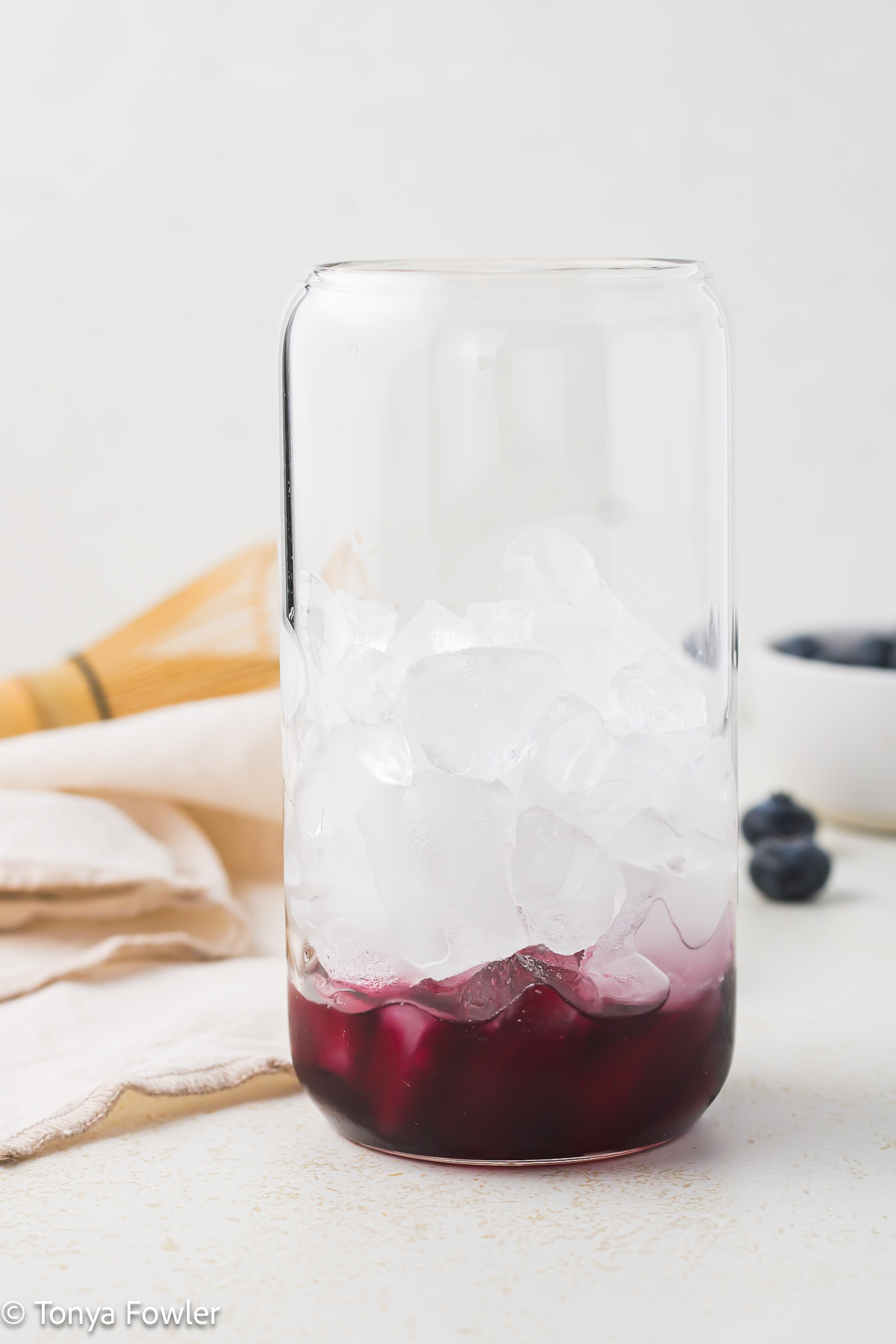 Blueberry syrup in a glass.