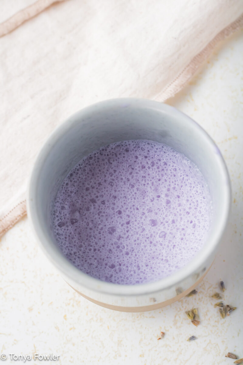 Close up image of lavender cold foam in a small cup.