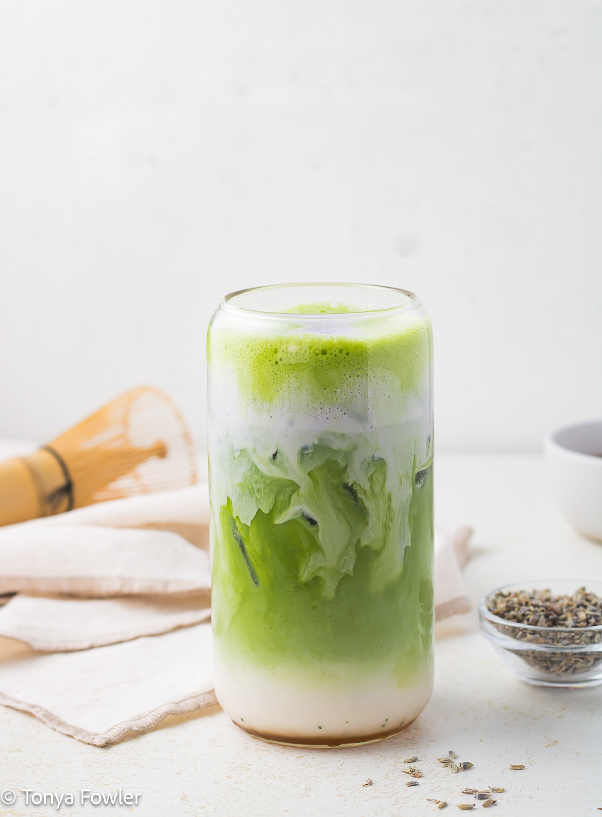 Straight on view of honey lavender matcha latte topped with lavender cold foam.