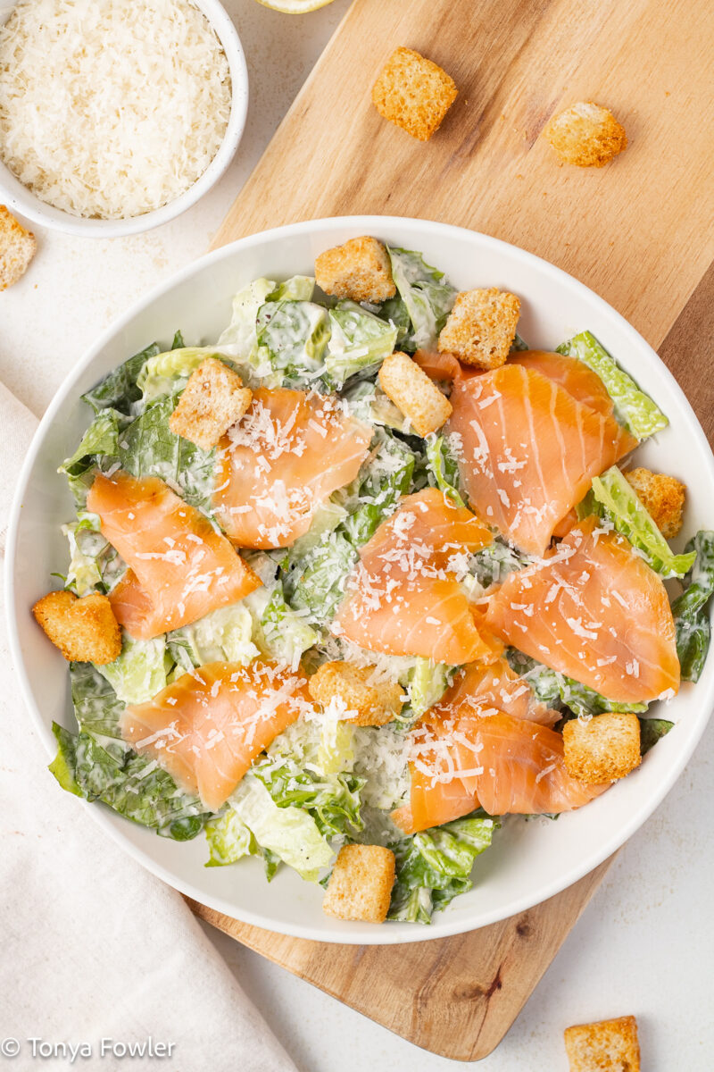 Cold smoked salmon on a salad in a bowl. 