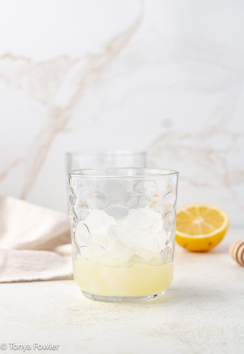 Lemon juice and ice in a glass.