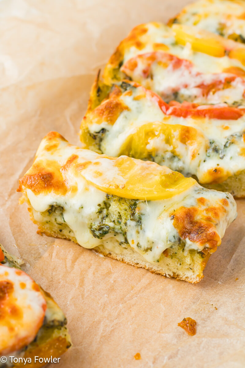3/4 view of slices of cheesy garlic bread.