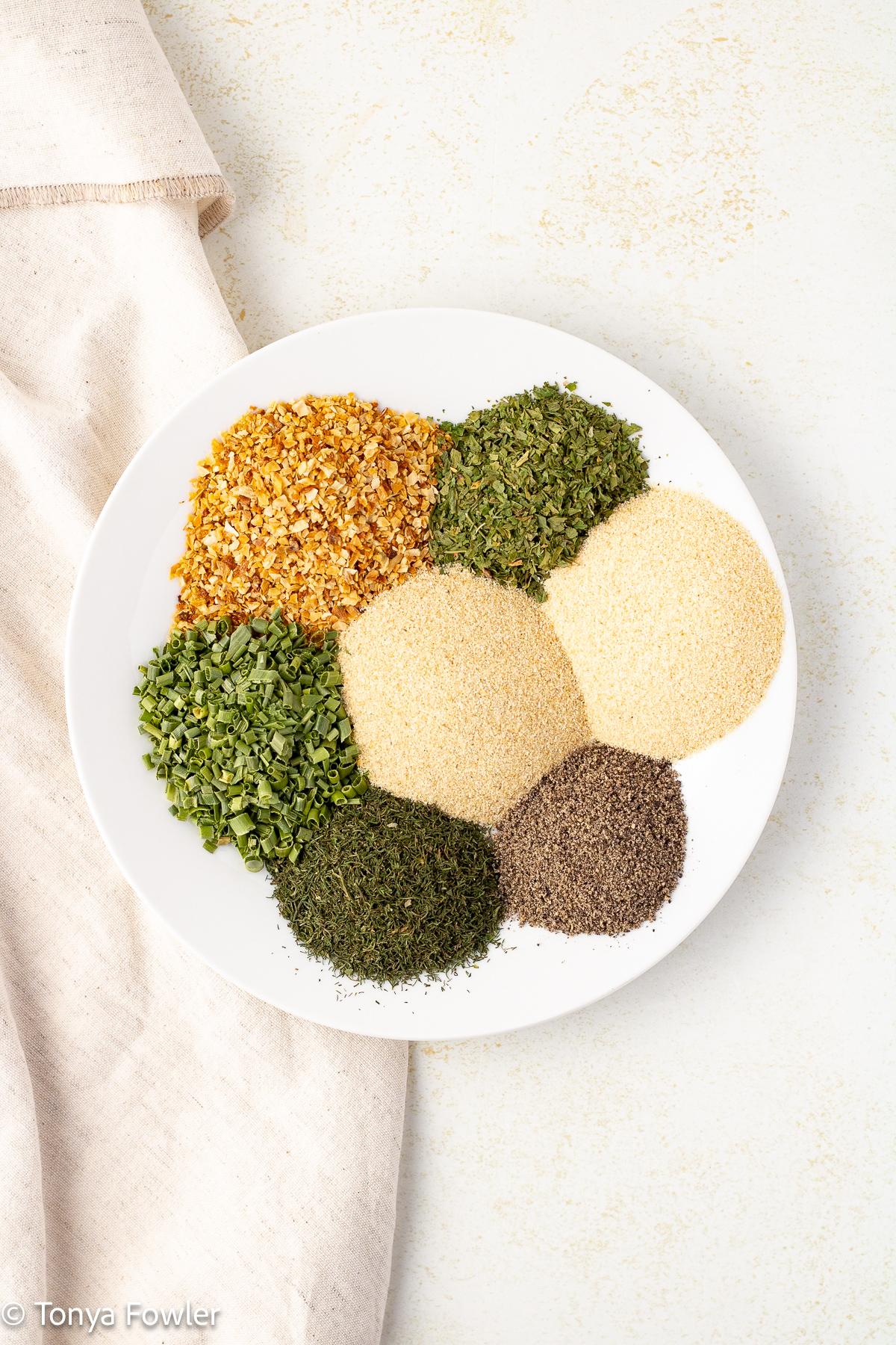 Overhead view of seasonings on a plate.