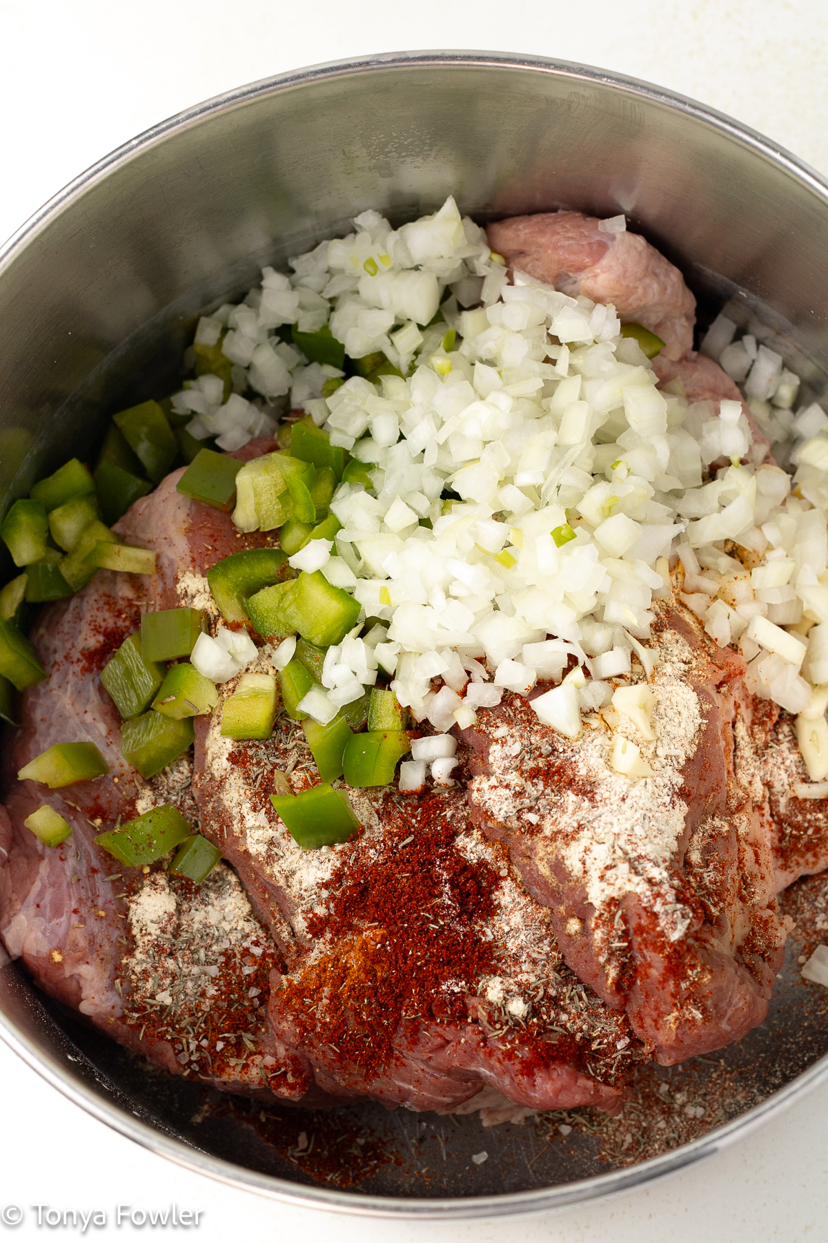 Beef, seasonings and vegetables in a pot. 