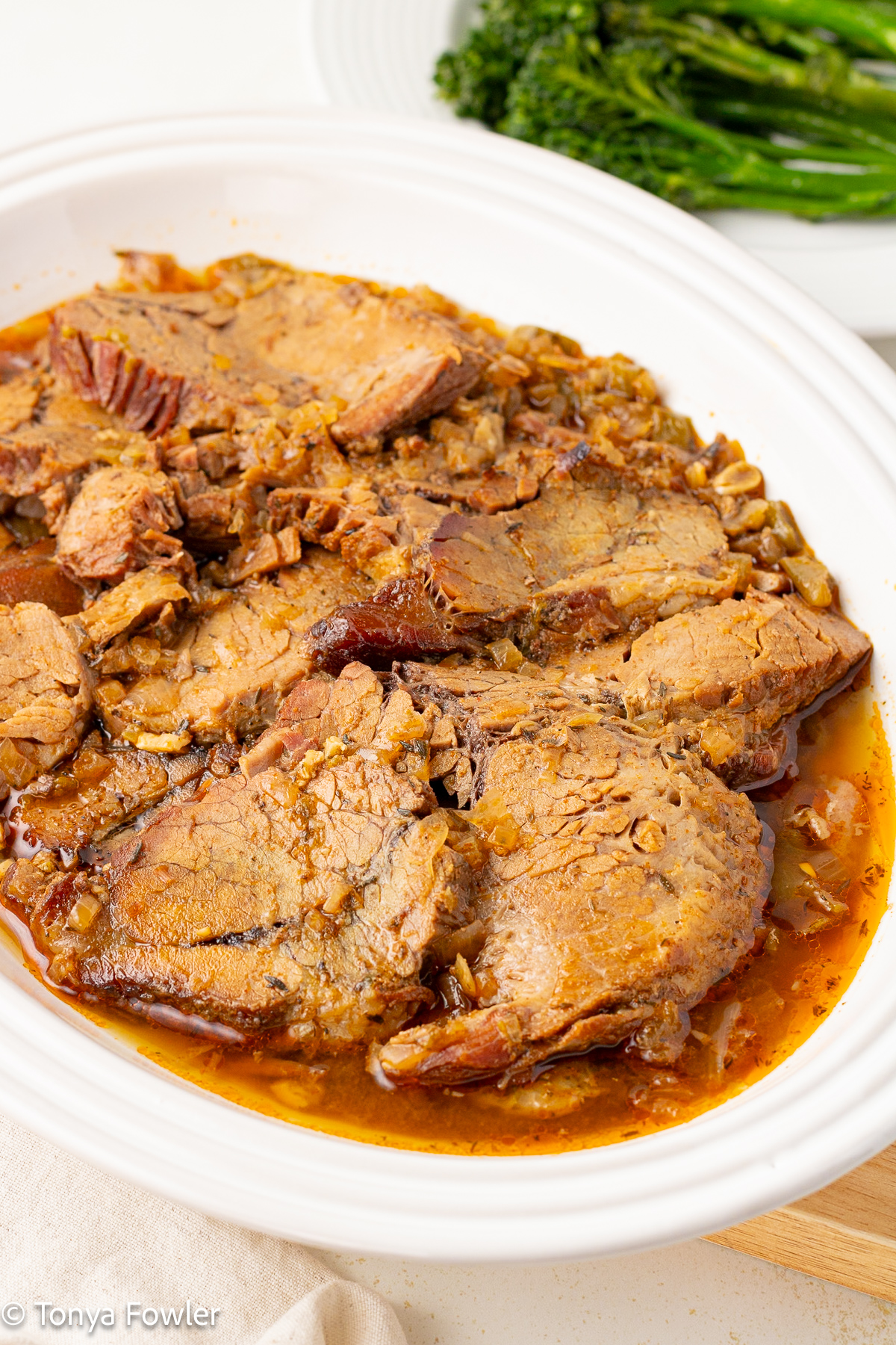 Close up image of sliced beef in a serving dish. 
