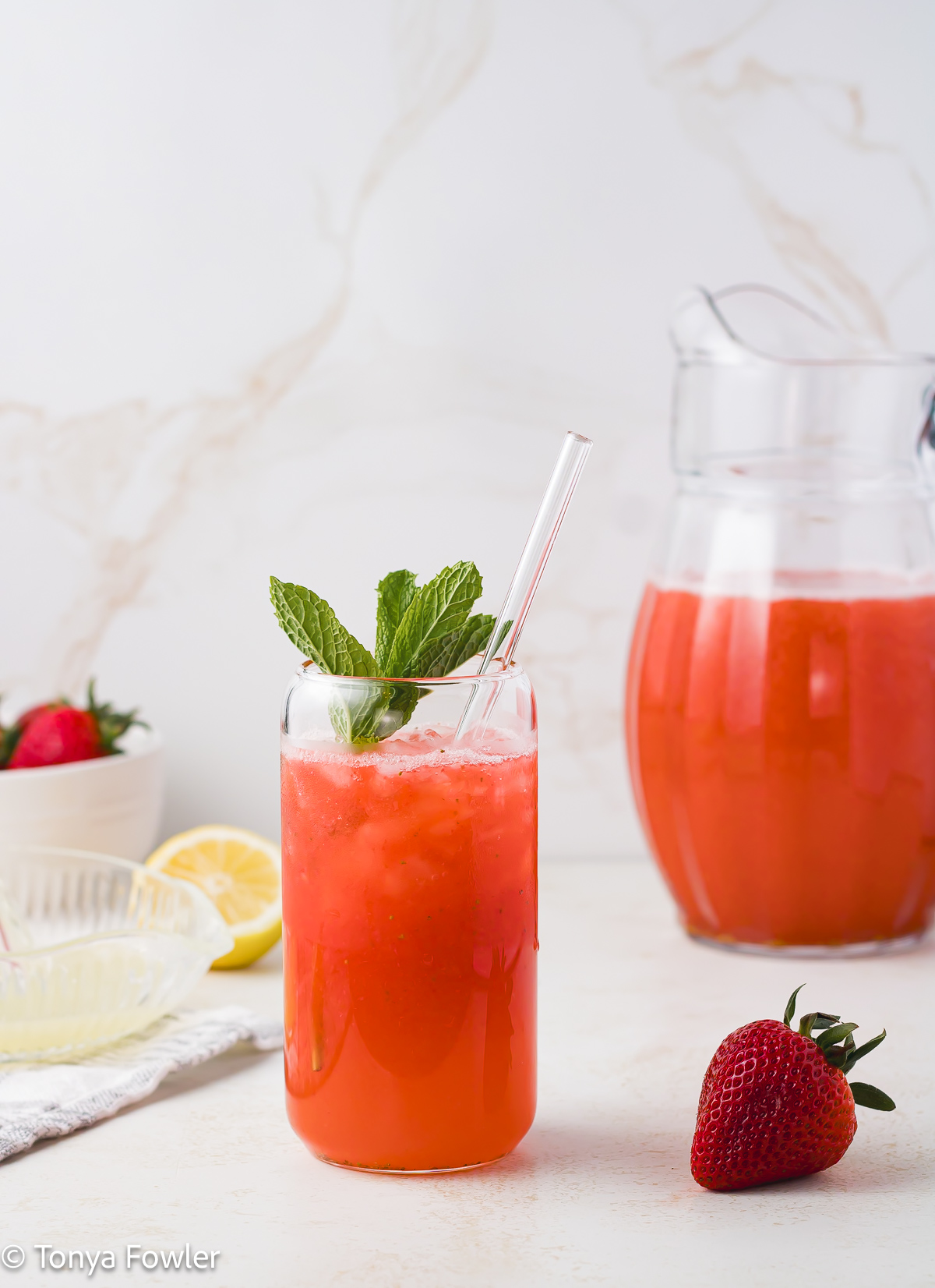 Straight on view of strawberry green tea lemonade in a glass.