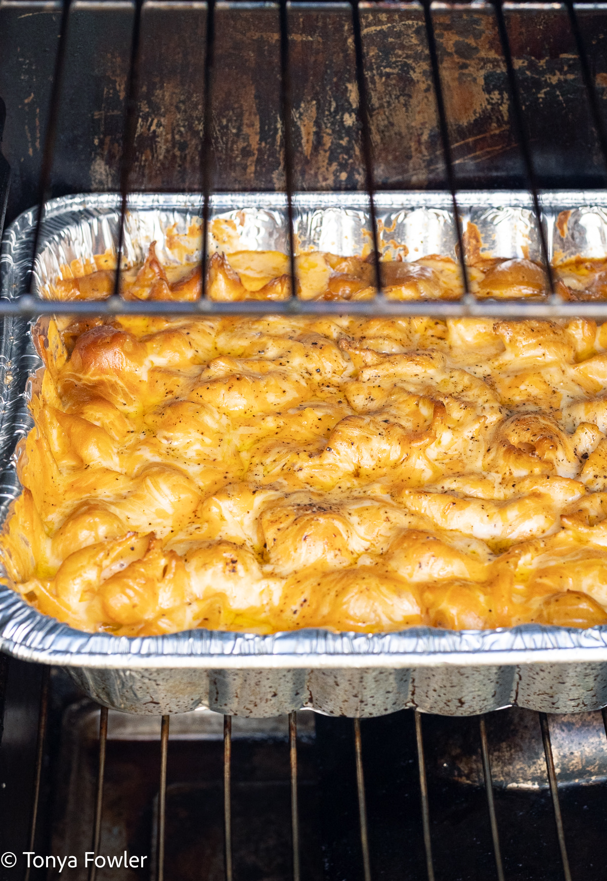 Straight on view of macaroni and cheese in an electric smoker. 