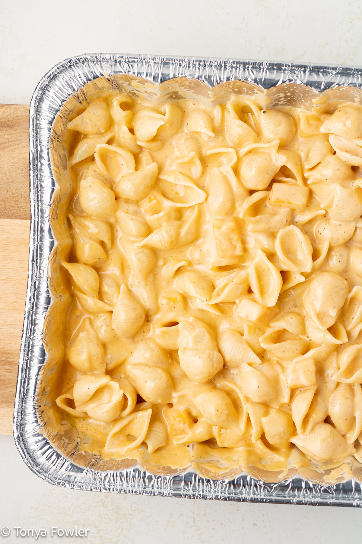 Pasta with cheese sauce in a disposable pan. 