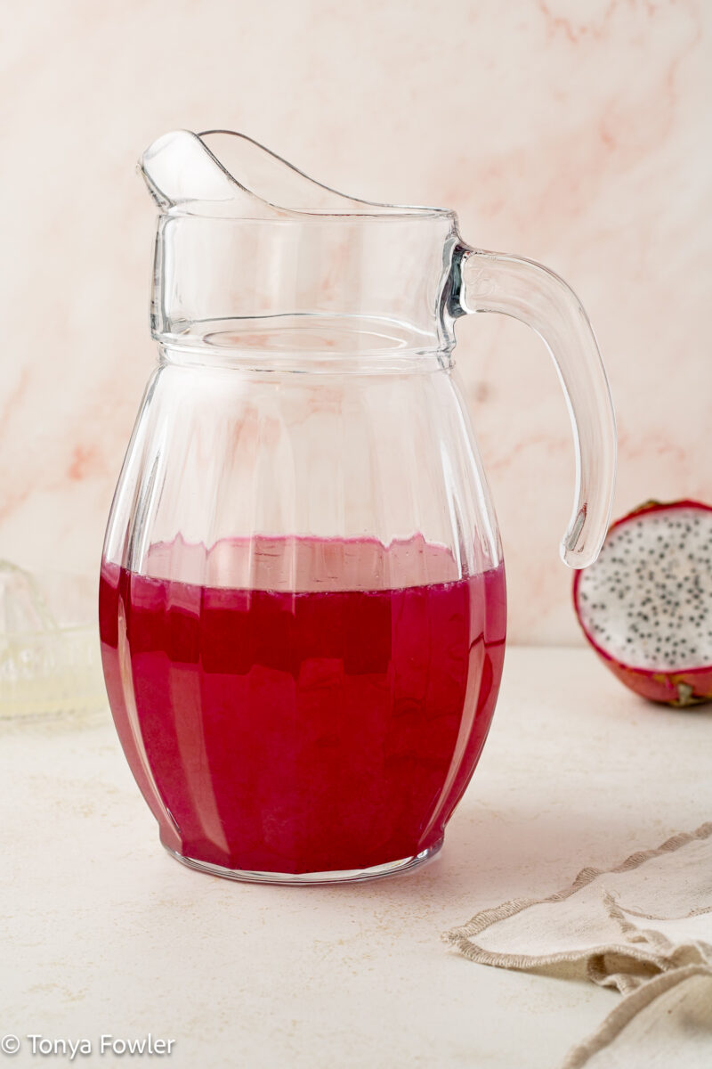 Straight on view of lemonade in a pitcher.