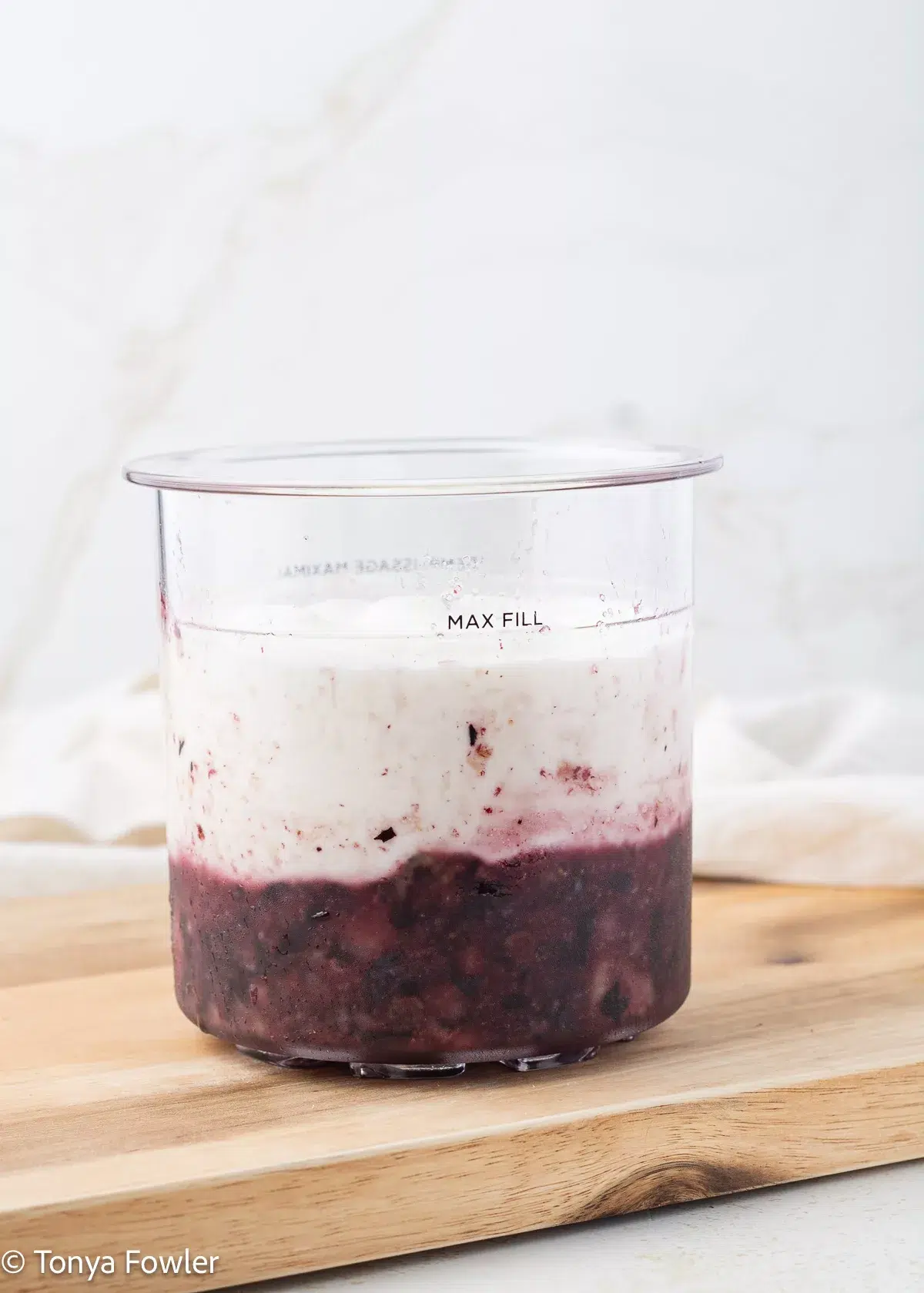 Fruit puree layered in a pint container with yogurt.