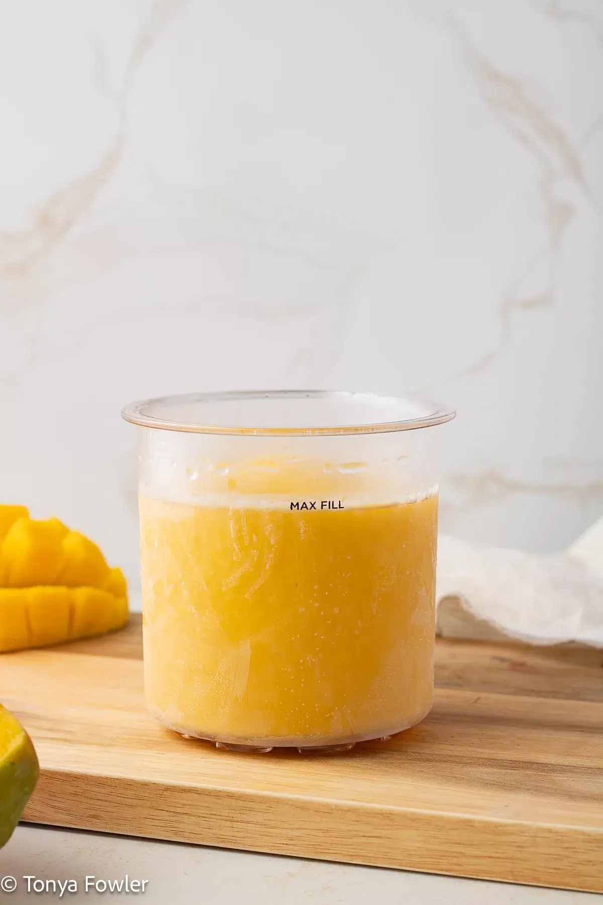 Frozen mango puree in a pint container. 