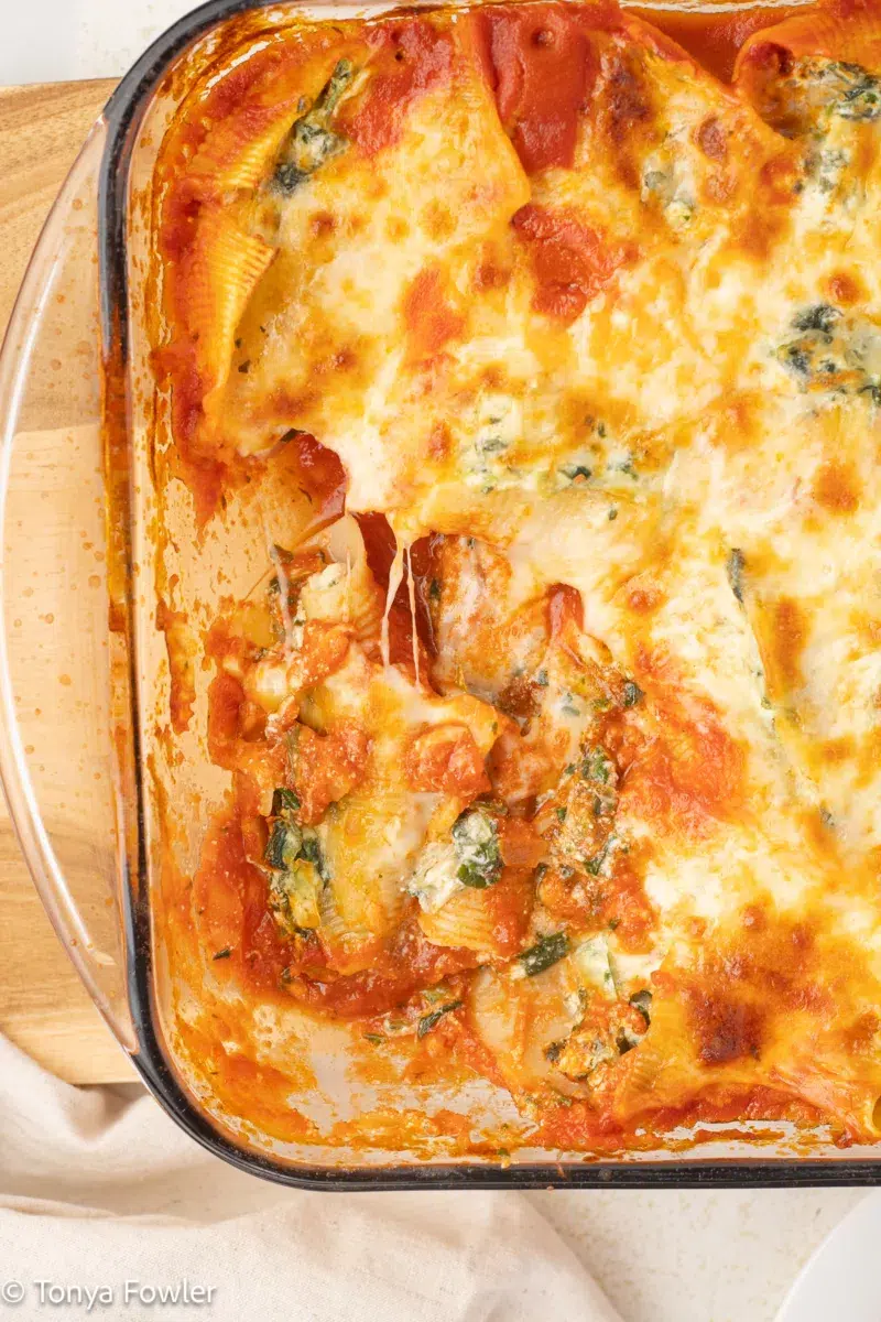Overhead view of stuffed shells in a baking dish.
