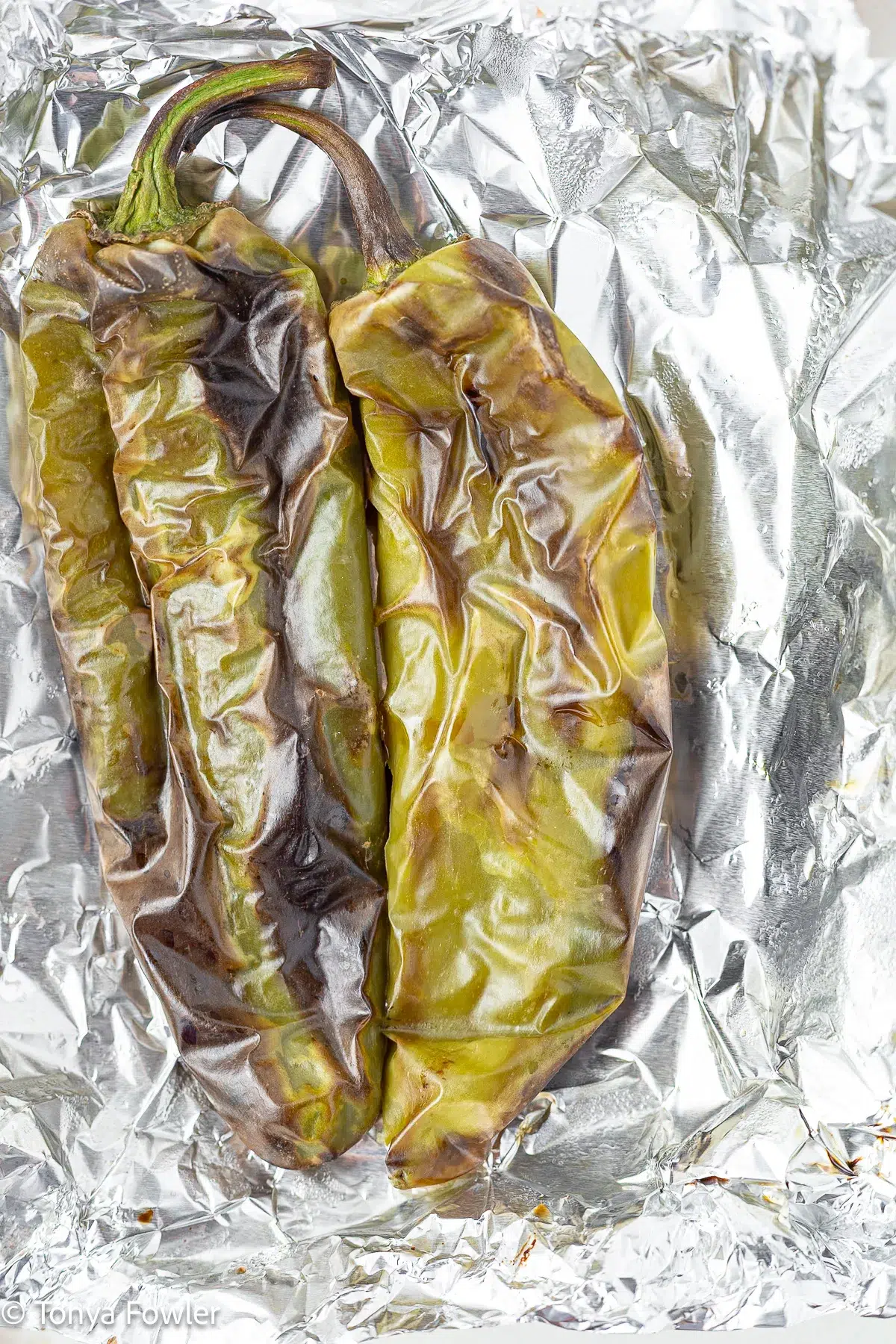 Roasted chiles on aluminum foil.