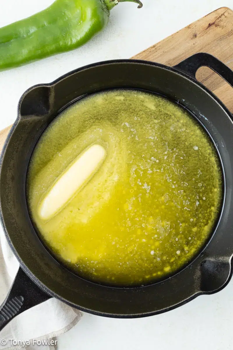 Butter melting in a cast iron skillet.