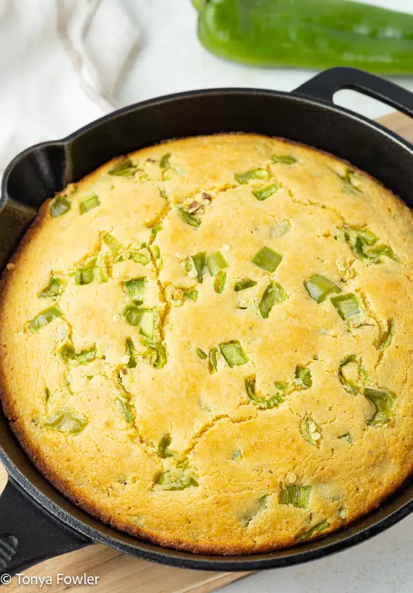 Close up image of hatch chile cornbread in a skillet.
