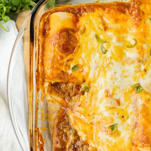Enchiladas in a baking dish.