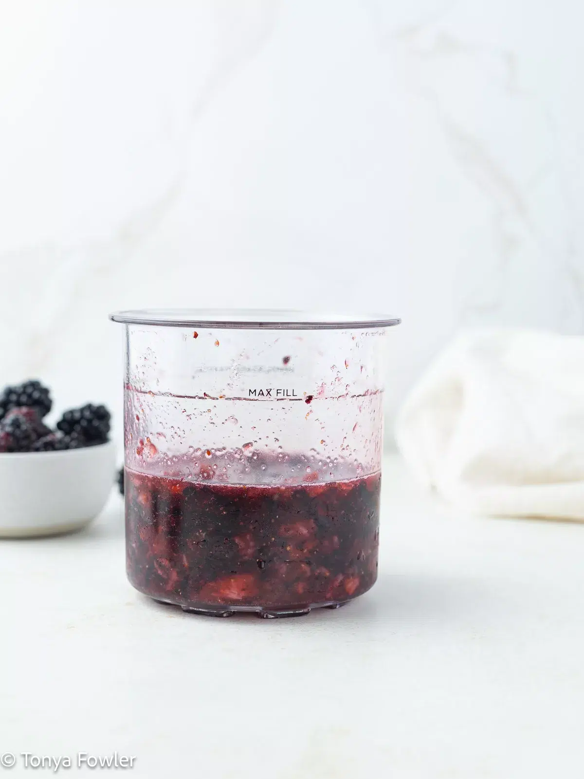Straight on image of mashed berries and sugar in a pint container.