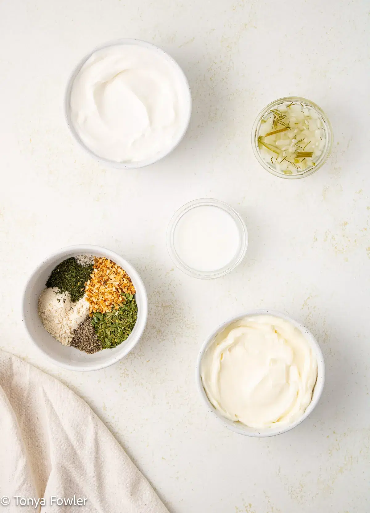 Ingredients for dill ranch dressing on a table.