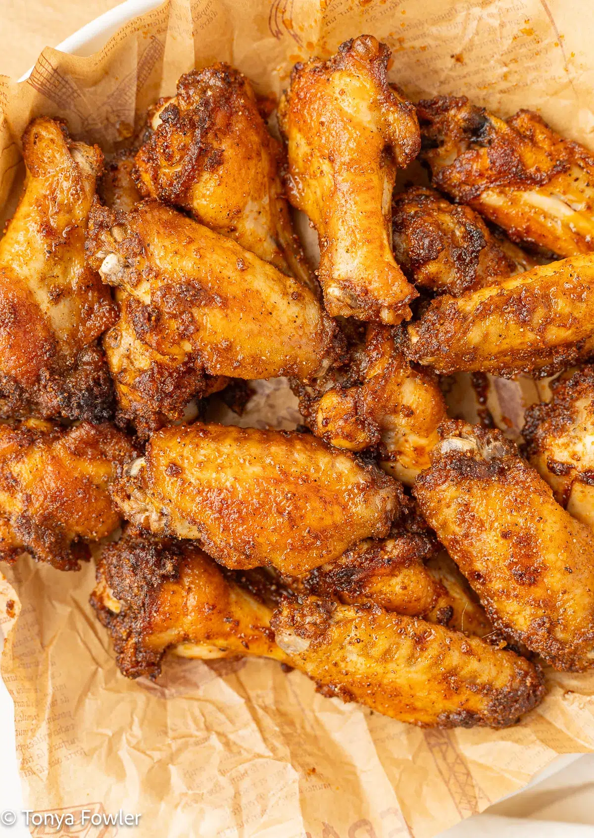 Baked chicken wings in a bowl.