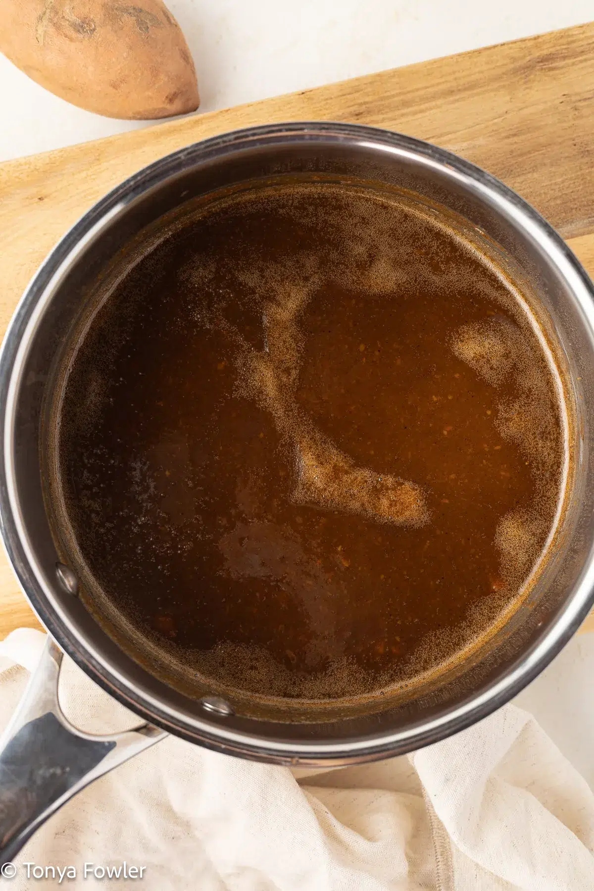 Cooked sweet potato syrup in a pot.