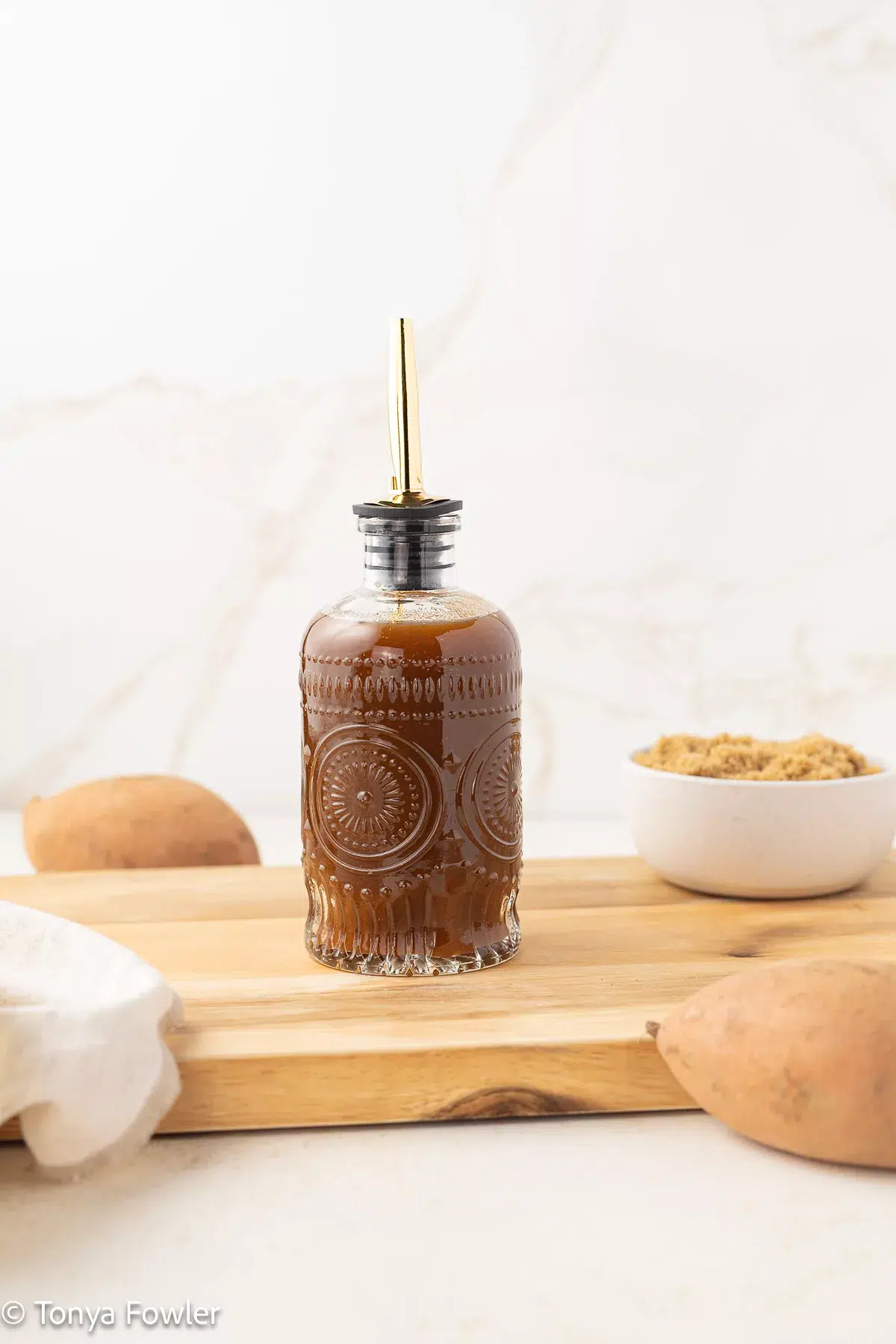 Sweet potato syrup in a syrup bottle.