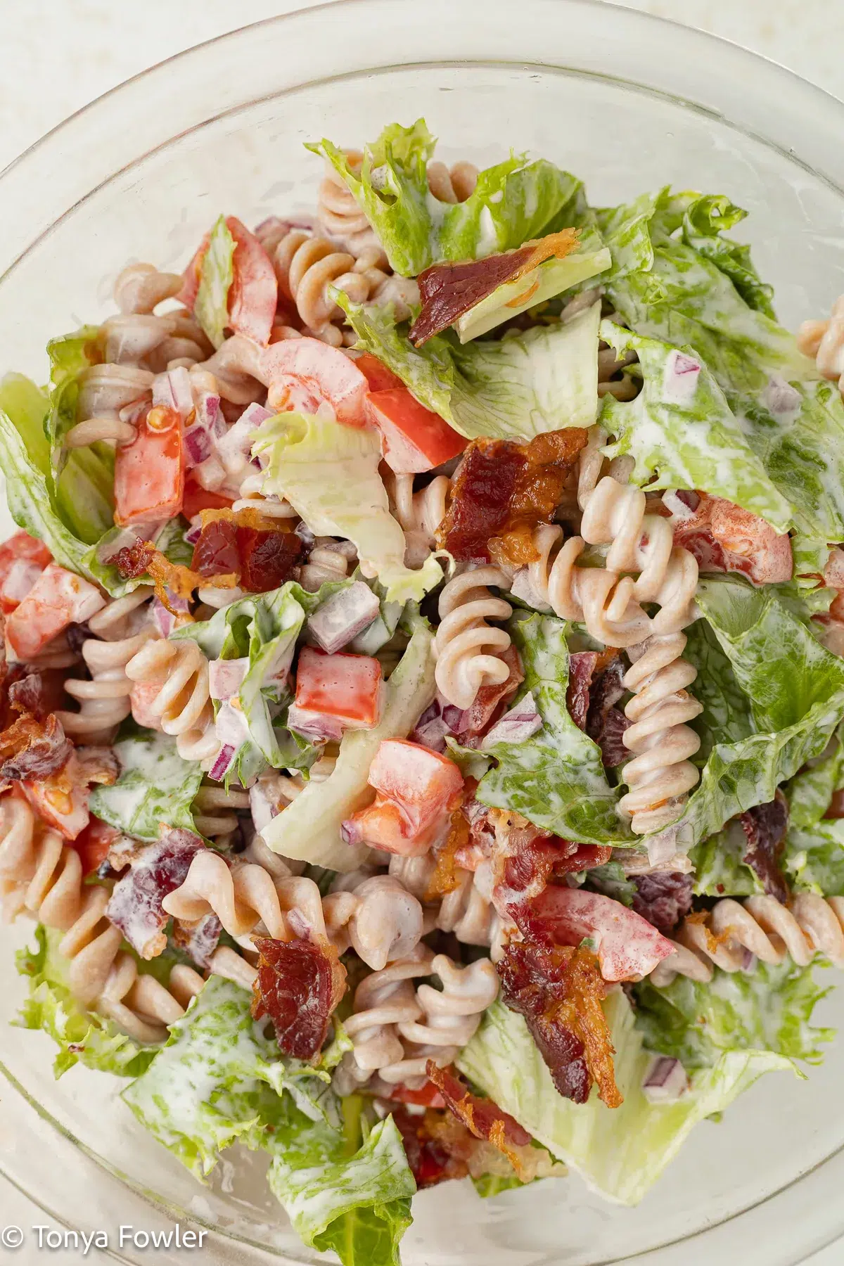 Close up image of beef bacon blt pasta salad in a bowl.