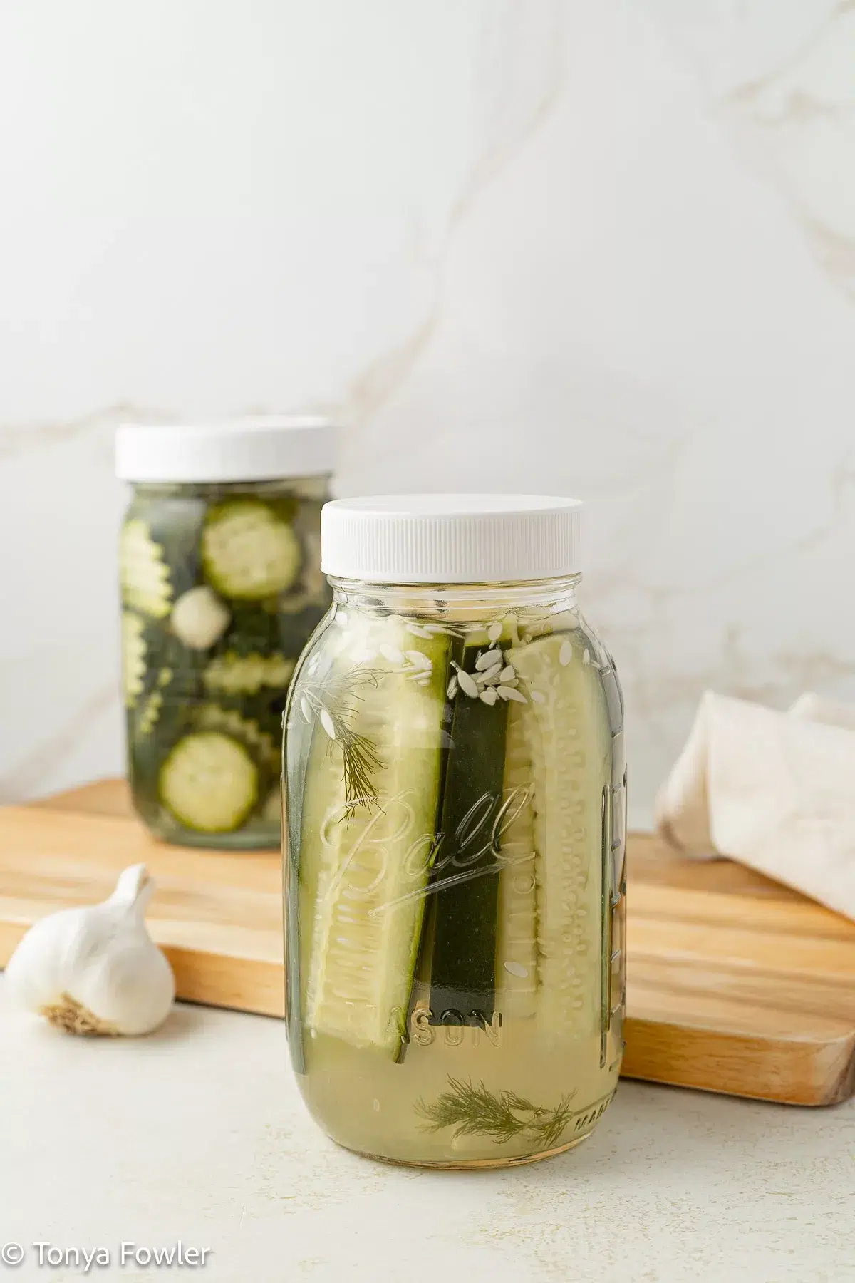 Refrigerator pickles in jars.