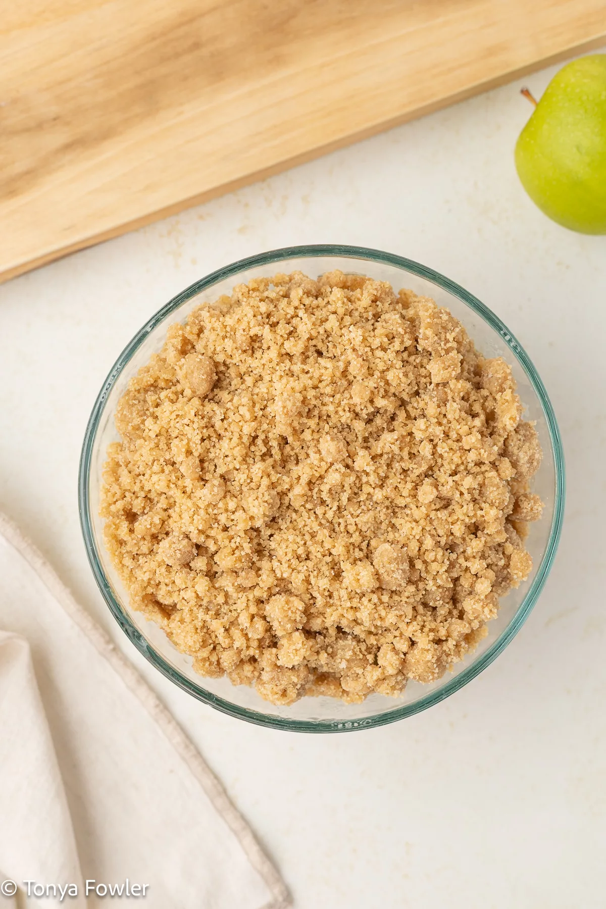 Unbaked apple crumble in a baking dish.