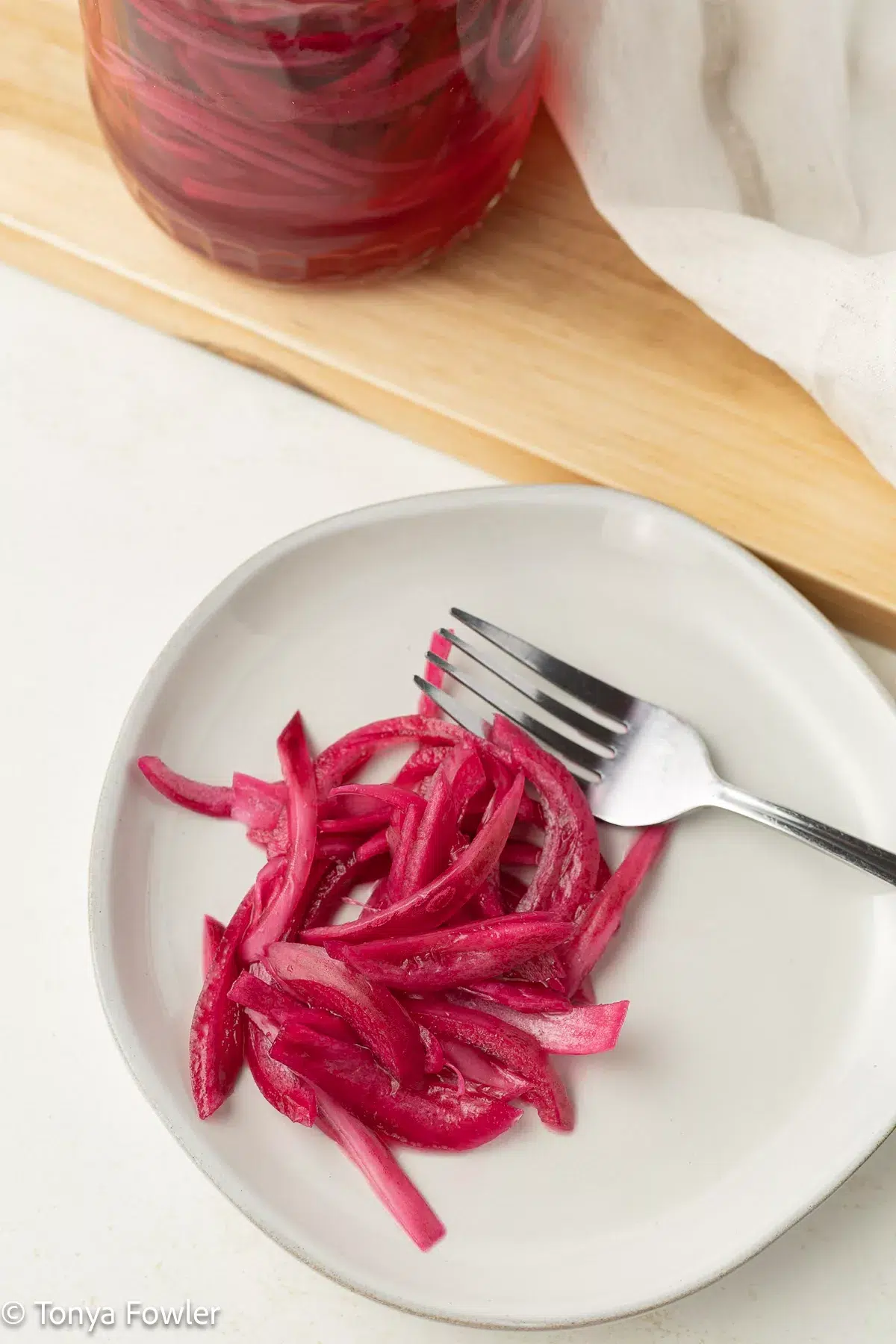 Pickled red onions on a plate.