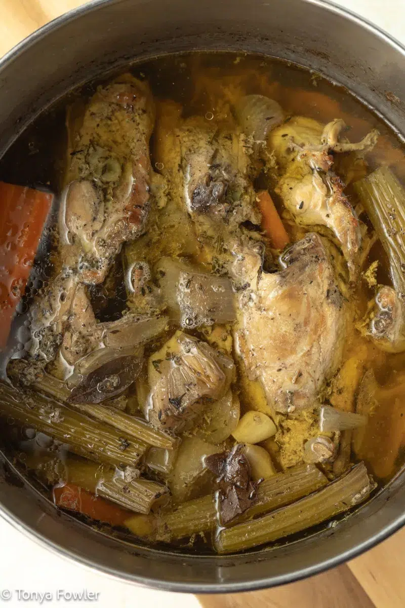 Cooked chicken broth in a pot.